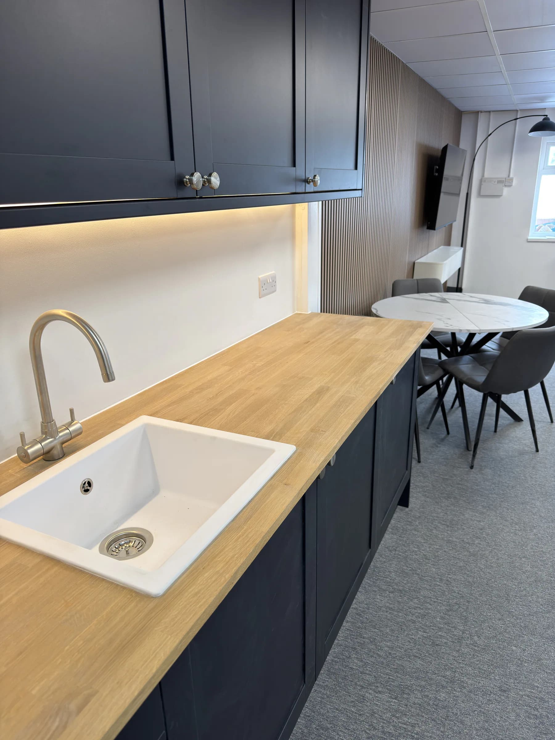 Oak kitchenette worktop, sink and meeting area within the commercial office fit-out
