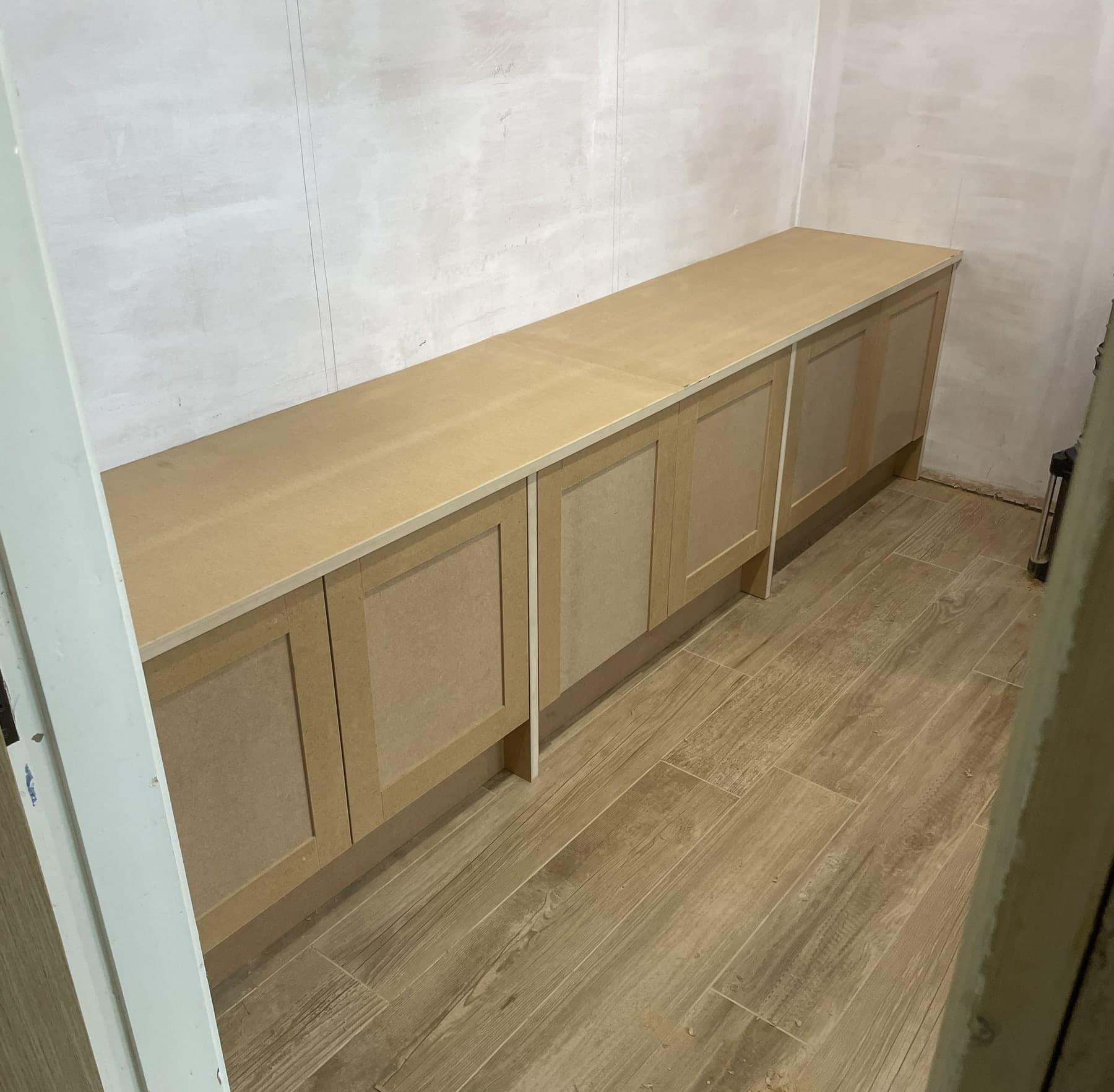 Fitted media unit cabinetry installed along a wall