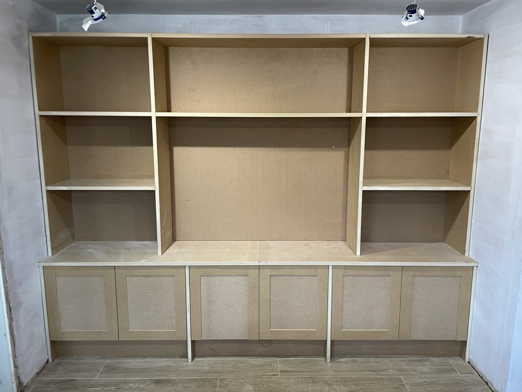 Bespoke fitted media unit with open shelving and cupboards